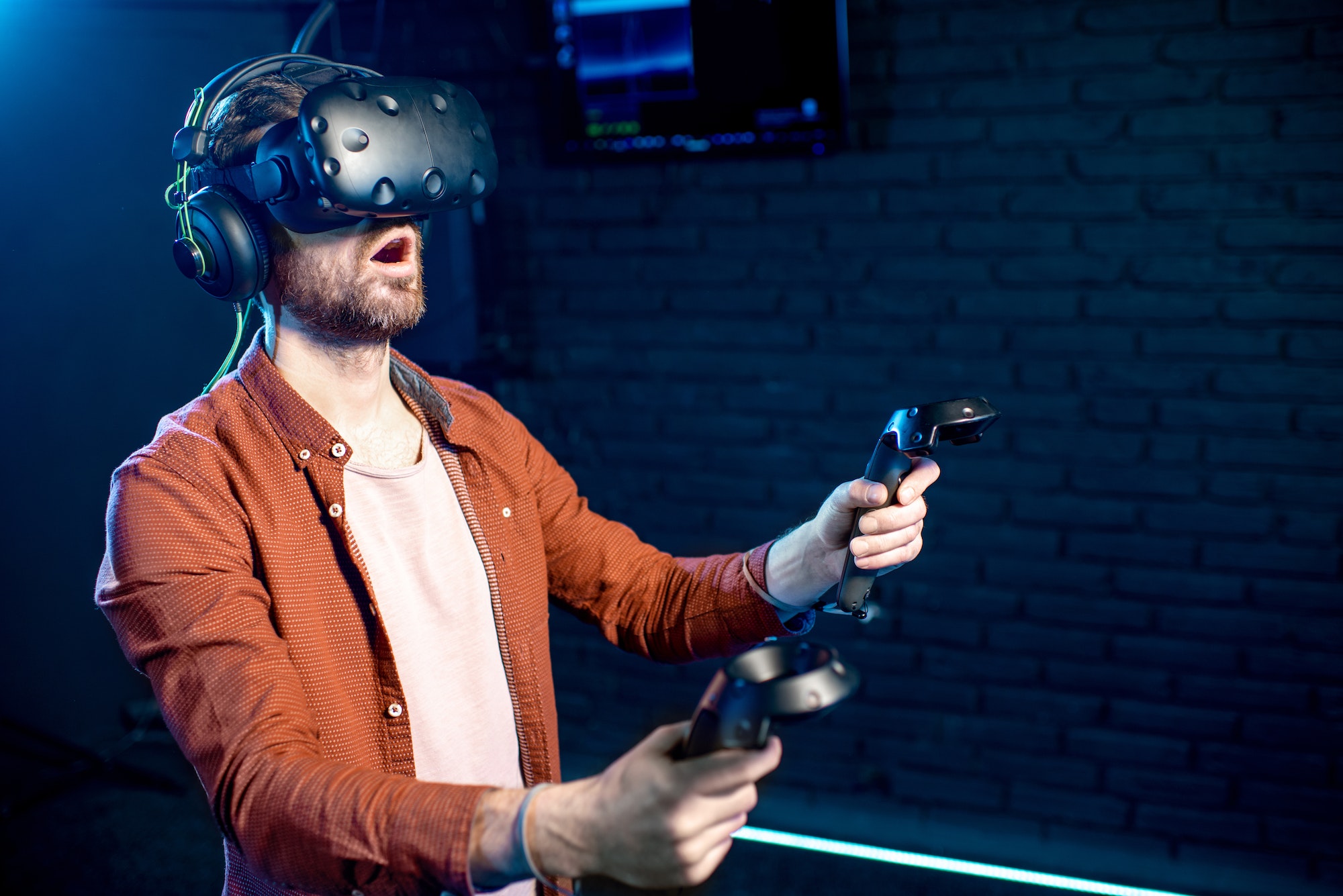 Man playing game with virtual reality headset in the club